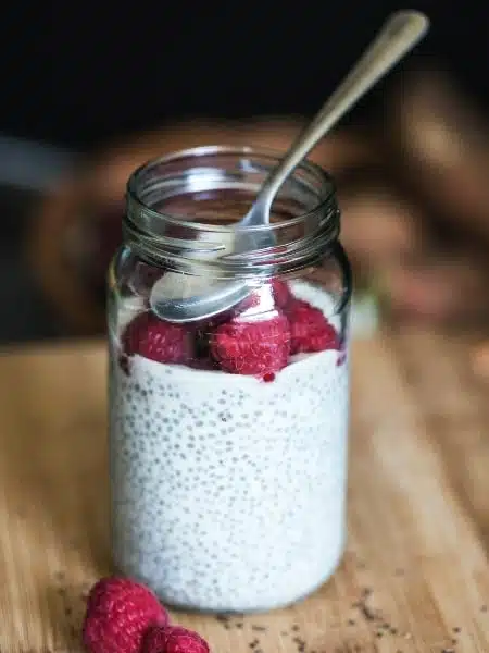chia seed pudding with raspberries in a jar.