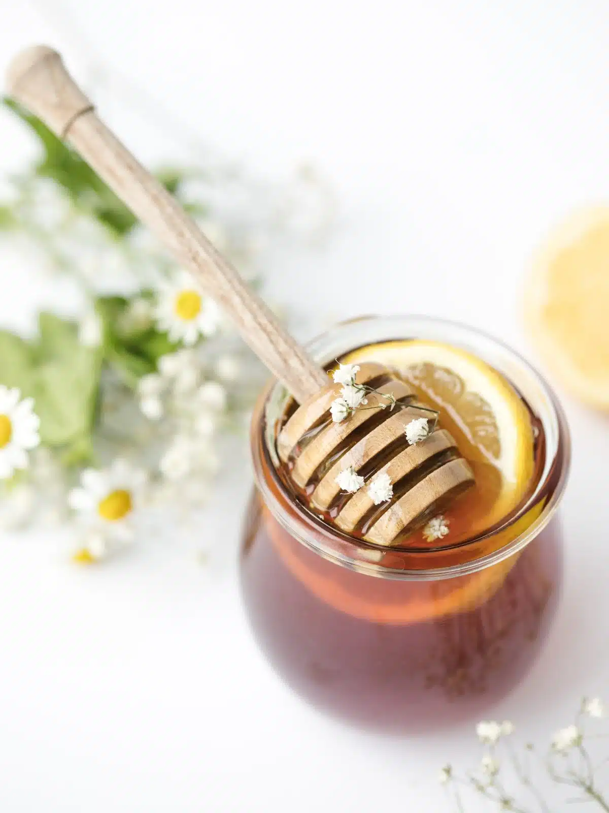 tea in a glass jar with honey and lemon.